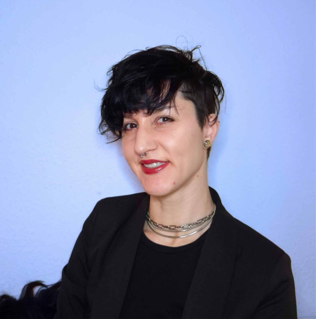 Molly-blue-bkgrd-cropped-headshot-SMALLEST-under-1-MB