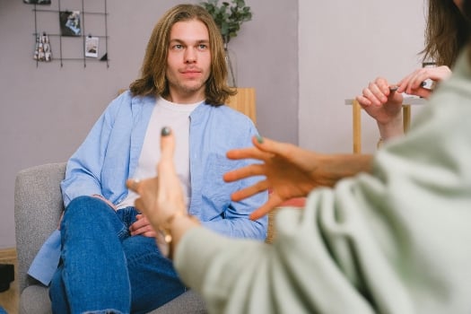 a person talking to a therapist about navigating recovery