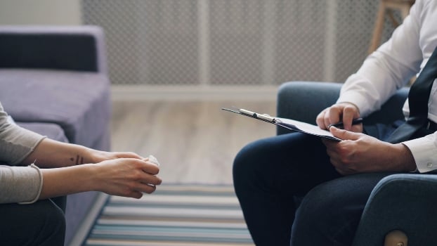 a person holding a tissue and a person holding a pad